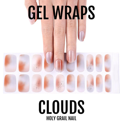 Pink nude cloud design gel nail wraps with hand showing finished manicure