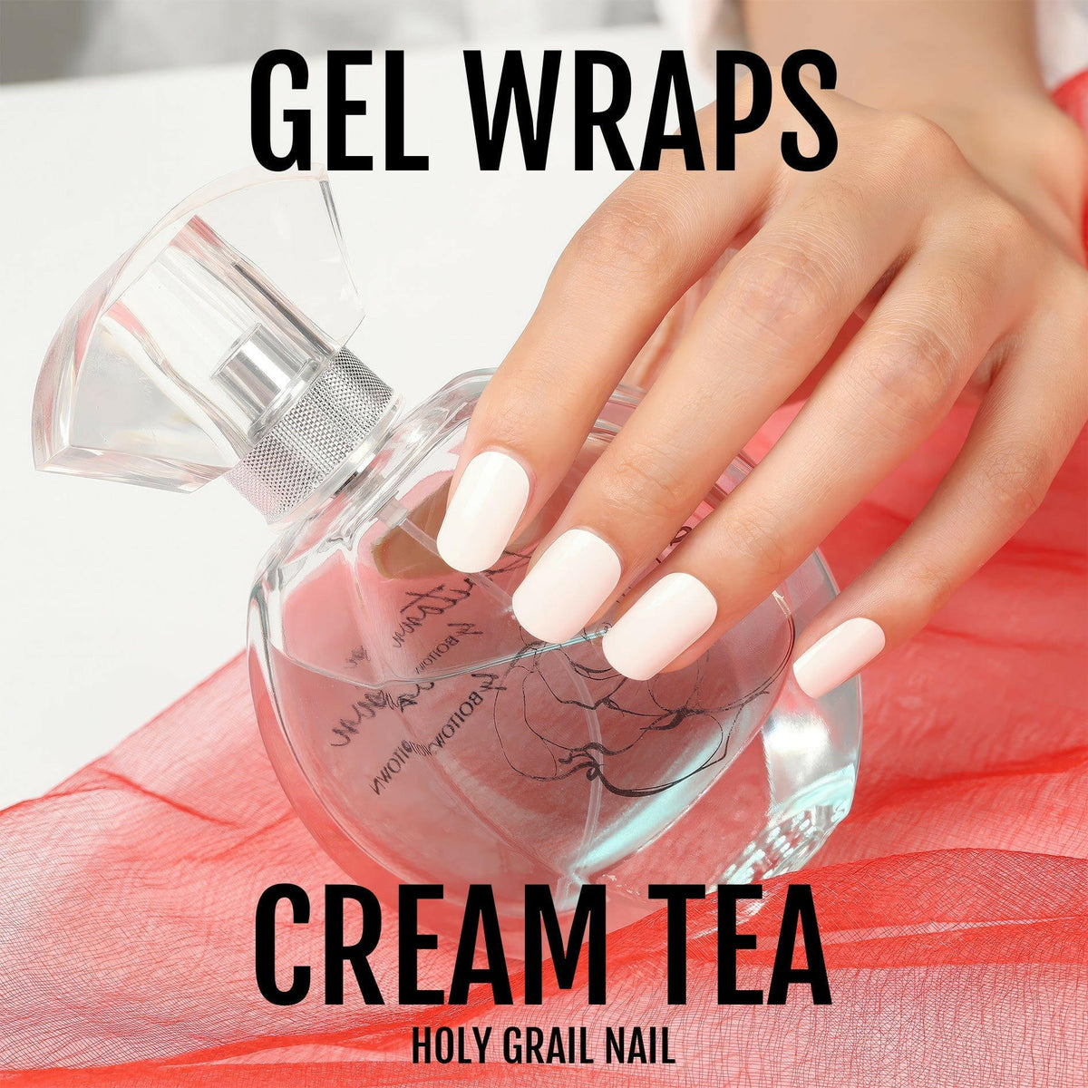 Hand with cream white gel nail wraps holding glass perfume bottle lifestyle shot