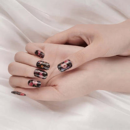 Dark floral gel nail wraps on hand with pink and burgundy flower patterns