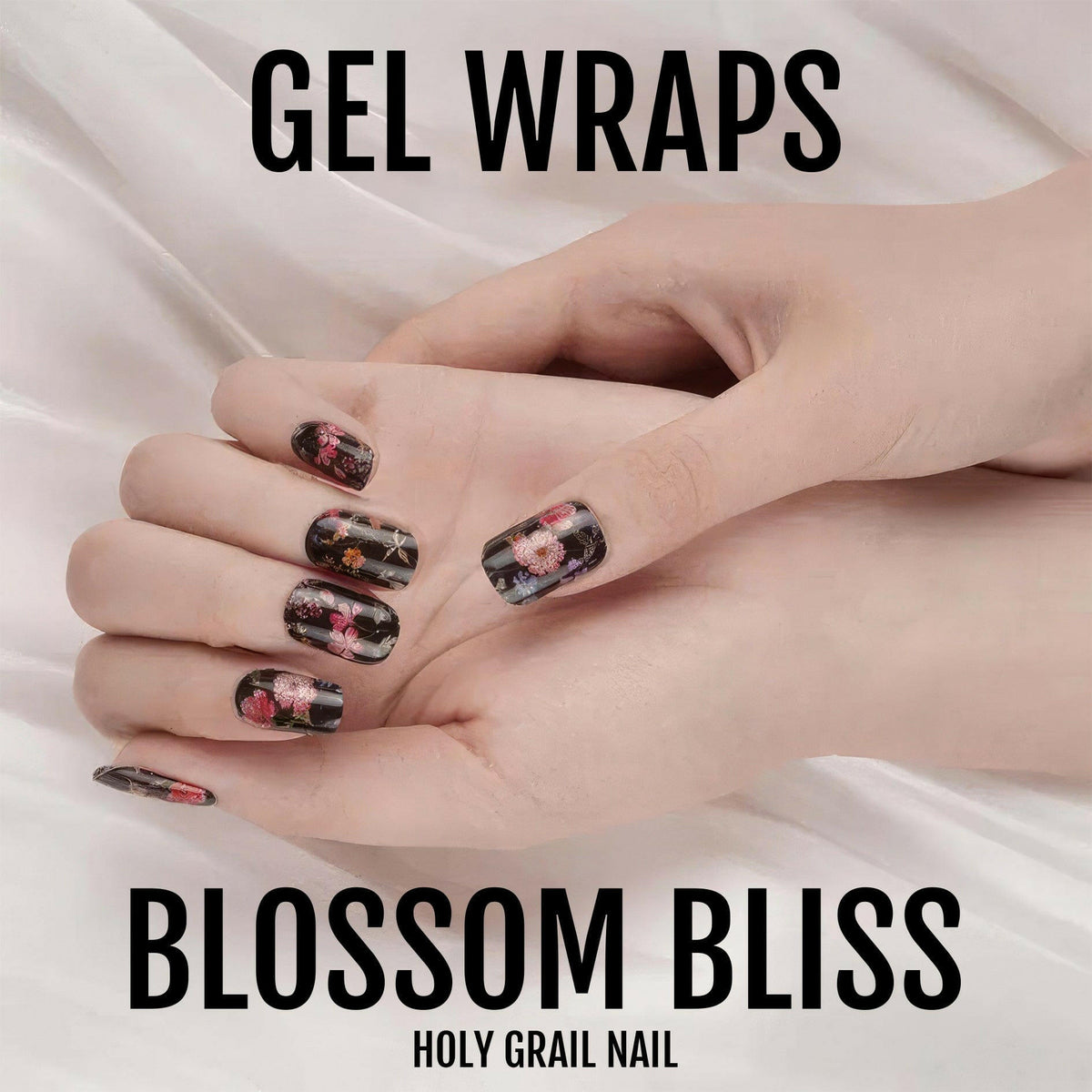Dark floral gel nail wraps on hand displaying black base with pink blossom design
