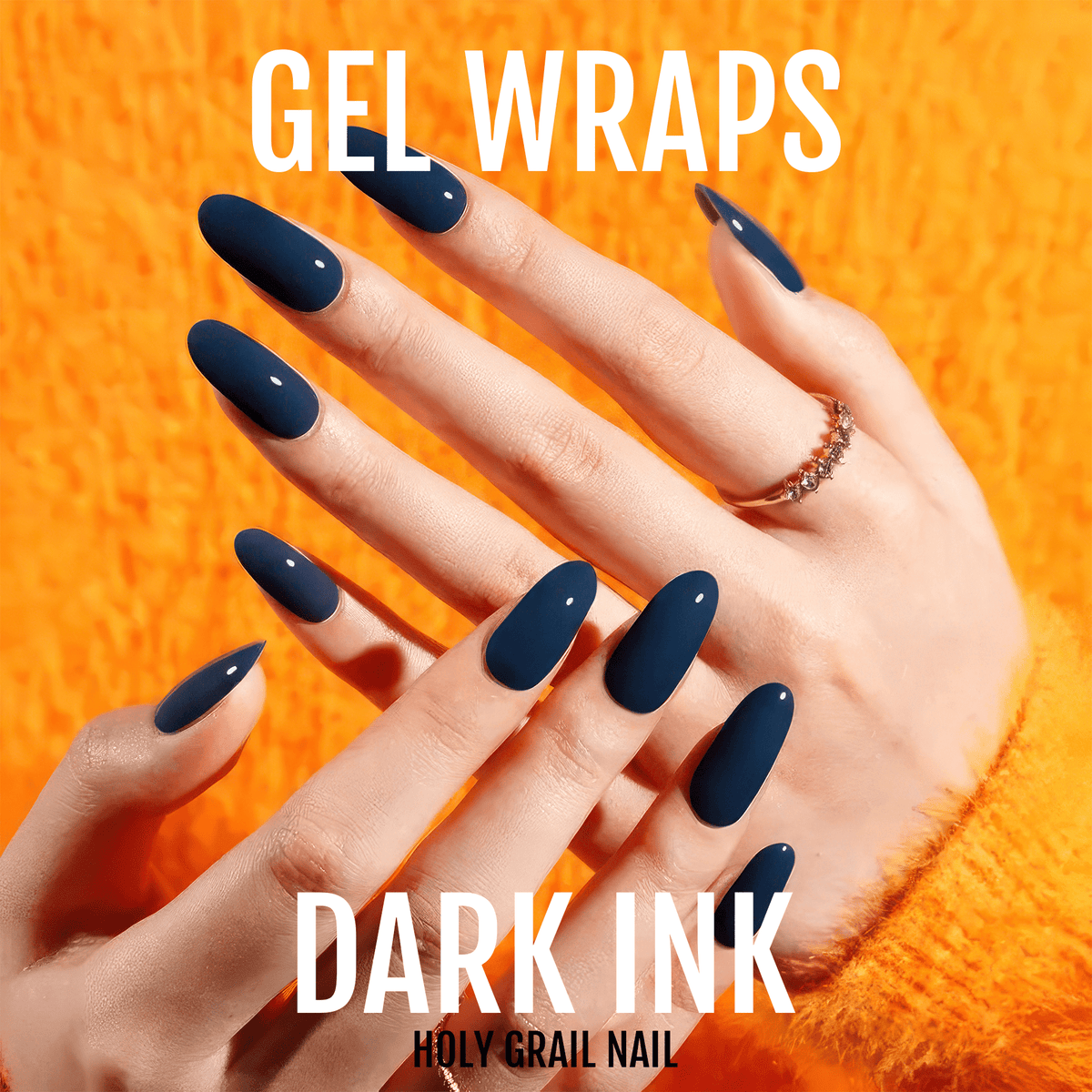 Dark navy blue glossy gel nail wraps on hand against orange textured background