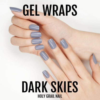 Hands displaying dark grey gel nail wraps with glossy finish for at-home manicure