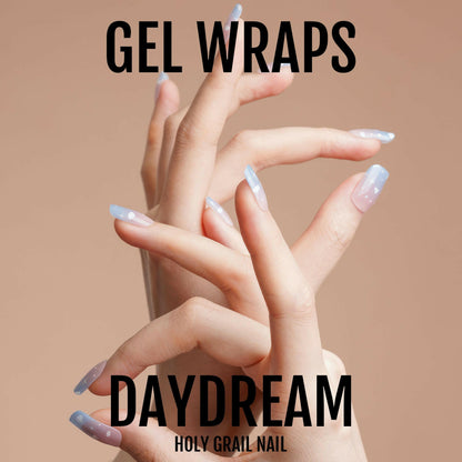 Multiple hands displaying blue cloud gel nail wraps manicure design