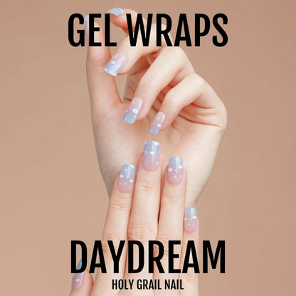 Blue cloud pattern gel nail wraps on hand showing dreamy sky nail art design