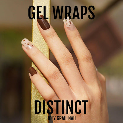 Distinct gel nail wraps featuring brown chocolate and nude polish with gold polka dot pattern