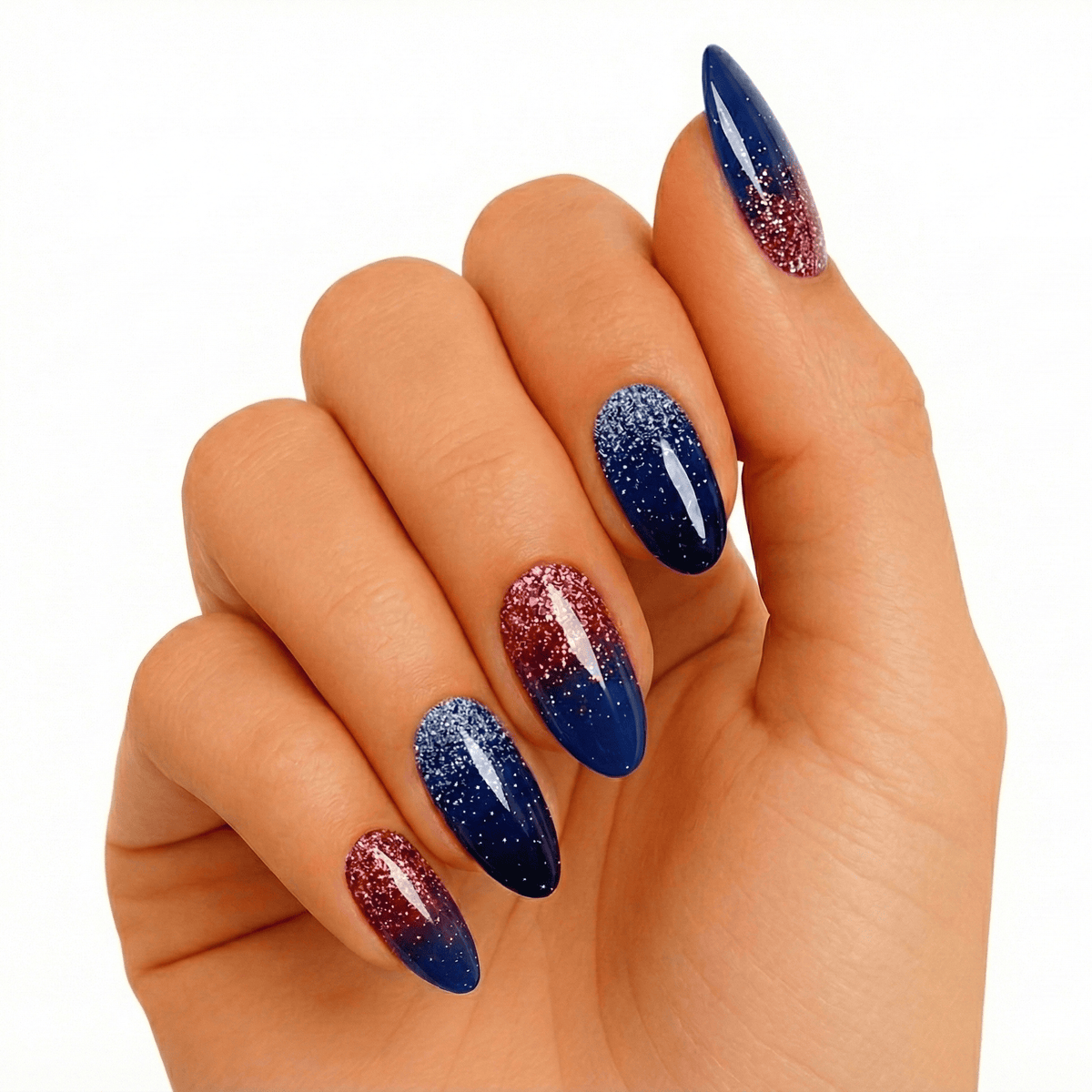 Navy blue gel nails on hand with rose gold glitter gradient almond shape