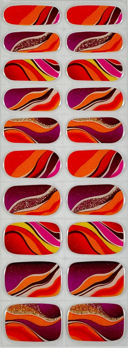 Colourful gel nail wraps featuring orange red burgundy abstract wave patterns with gold glitter details