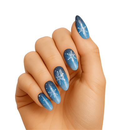 Blue gradient gel nail wraps with white snowflake designs on hand winter manicure