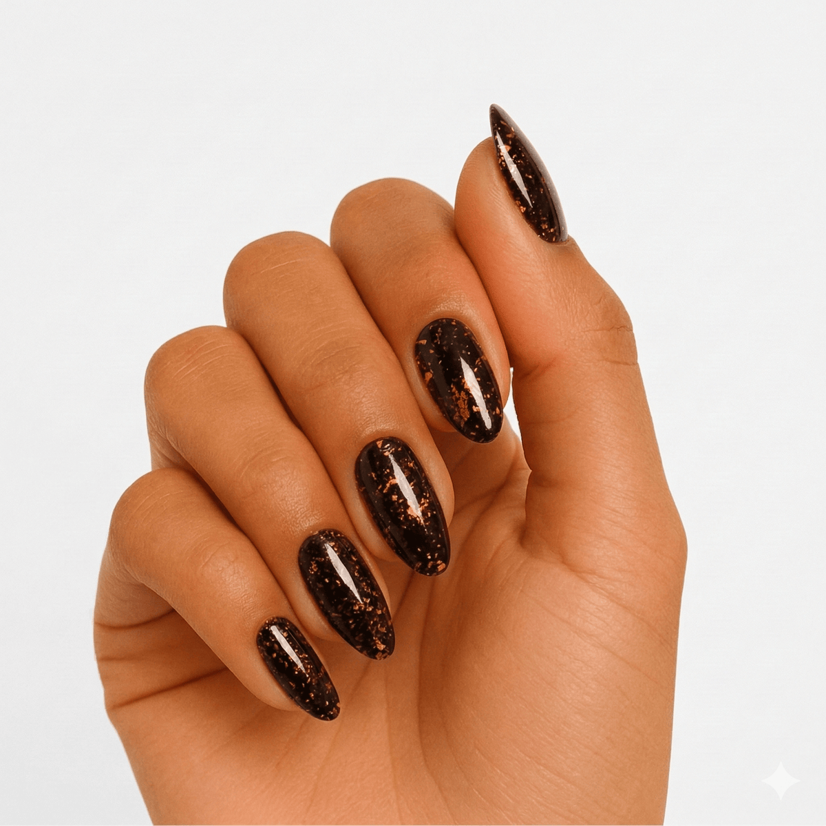 Bronze glitter gel nail wraps with metallic amber finish on hand
