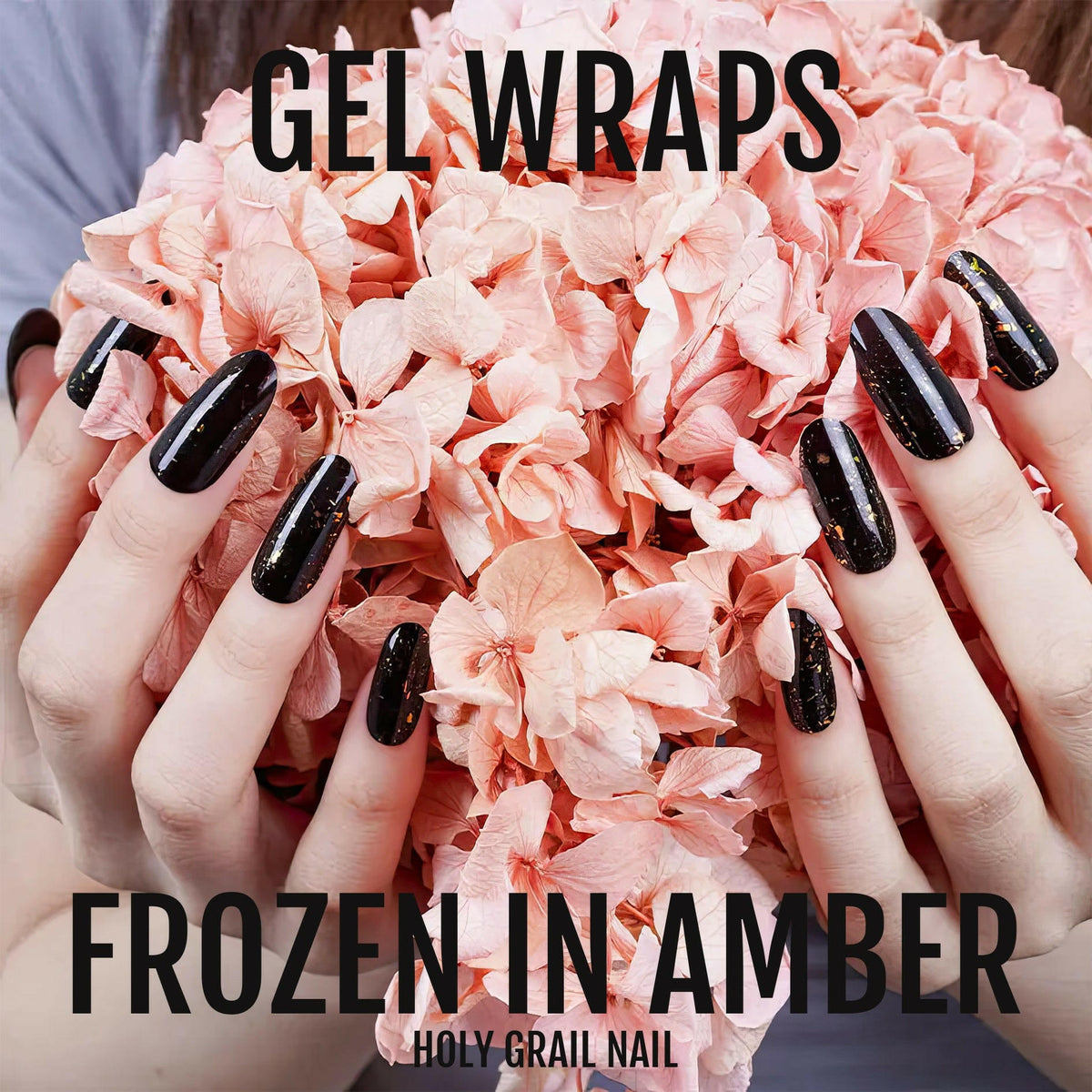 Black gel nail wraps with golden amber glitter effect on hand manicure