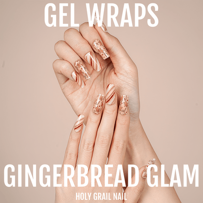 Gingerbread glam gel nail wraps on hand showing warm orange glitter and striped festive patterns