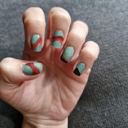 Geometric gel nail wraps in teal coral black colour block on hand