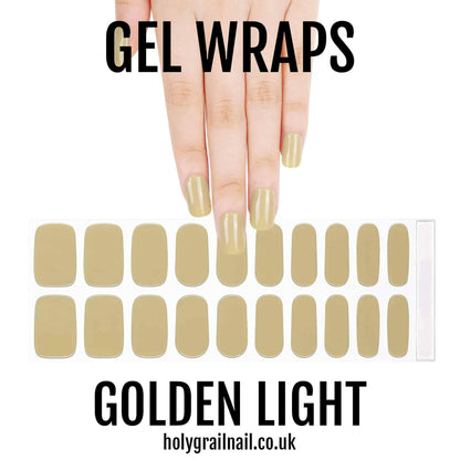 Golden light gel nail wraps on hand showing glossy metallic nude finish