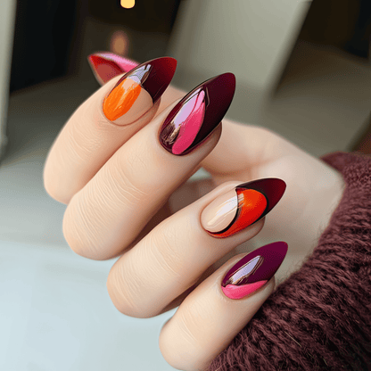 Close-up of red burgundy abstract gel nail wraps on almond shaped nails