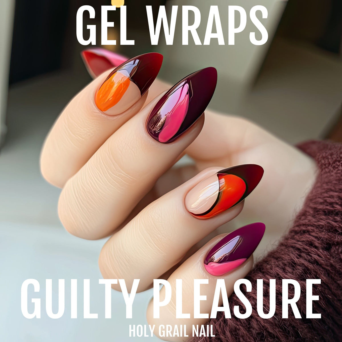 Almond shaped gel nail wraps on hand featuring red burgundy orange colour blocking