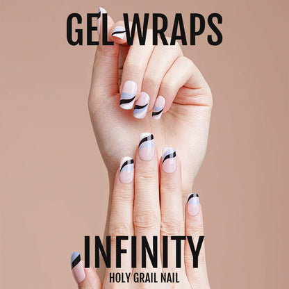 Hand wearing blue and black wave gel nail wraps with curved minimalist pattern design