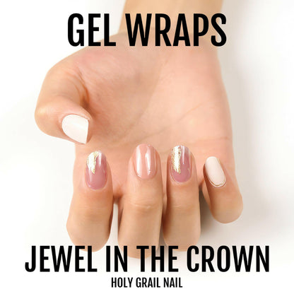 Neutral pink gel nail wraps with metallic gold foil details on hand soft glam manicure