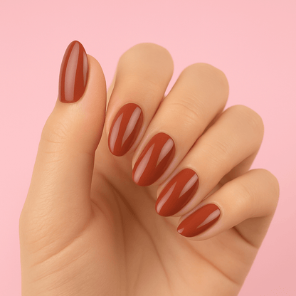 Leather brown gel nail wraps on hand with glossy finish against pink background