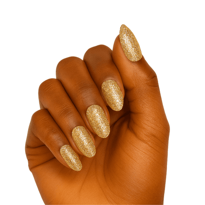 Hand wearing gold glitter gel nail wraps with champagne metallic finish for elegant manicure look