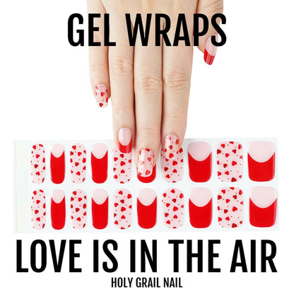 Valentine's gel nail wraps with red hearts and pink polka dot pattern on hand