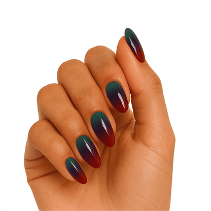 Green to burgundy ombre gel nail wraps on hand showing glossy gradient finish