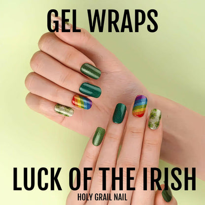Hand displaying luck of the Irish gel nail wraps with shamrock and rainbow patterns