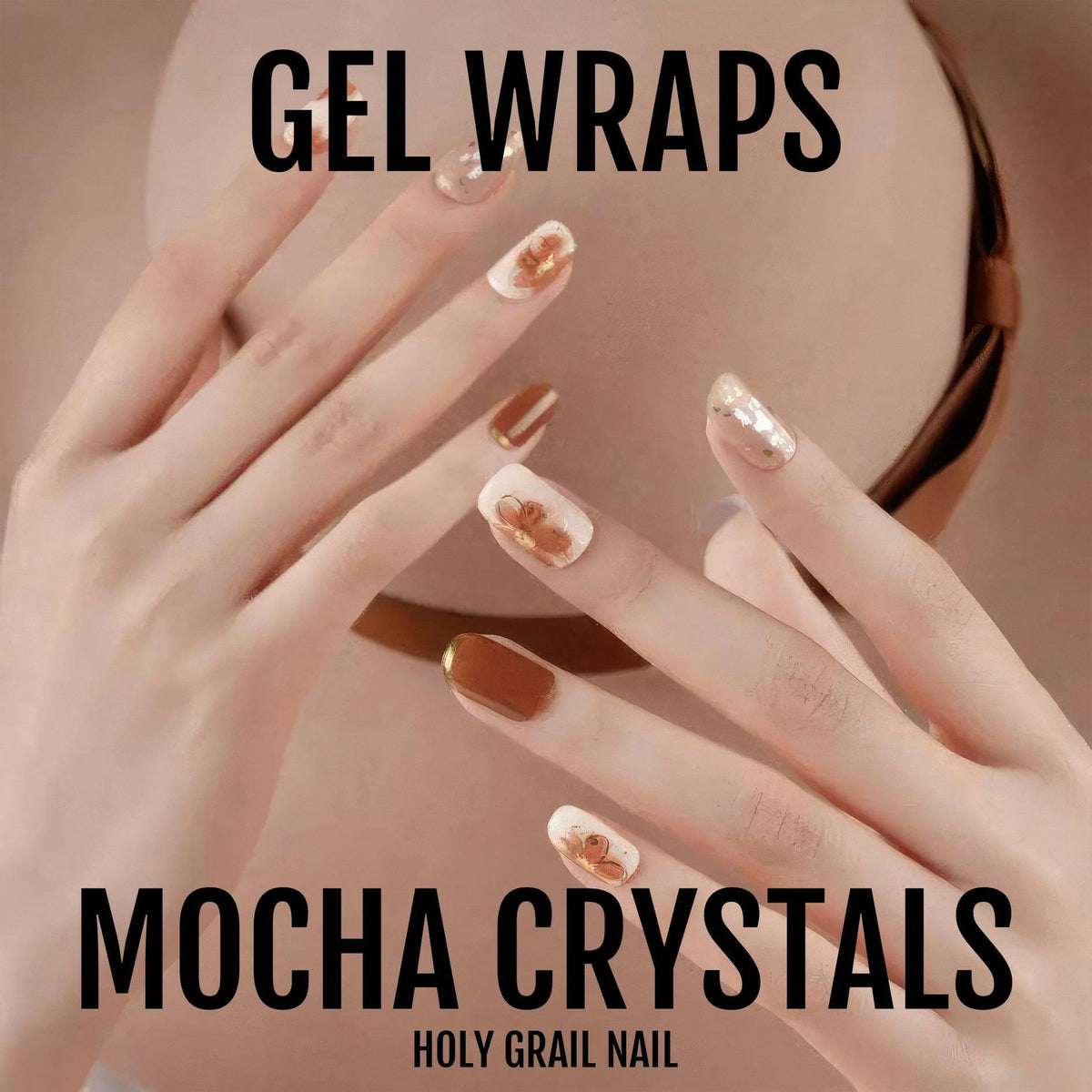 Hand wearing mocha crystal gel nail wraps with brown and nude textured designs
