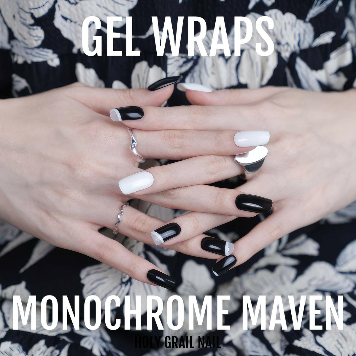 Hands with black and white gel nail wraps displaying monochrome nail art