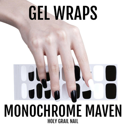 Hand displaying black and white gel nail wraps with monochrome nail art pattern