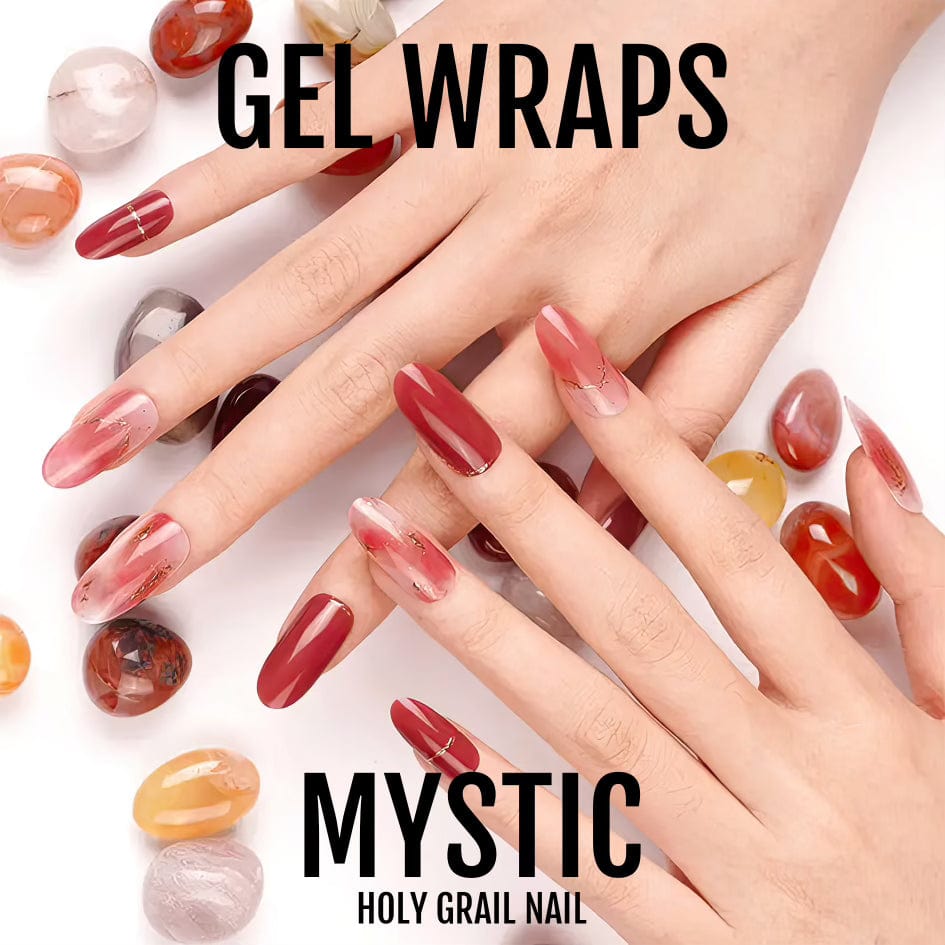 Two hands wearing red burgundy chrome gel nail wraps with gold chains surrounded by gemstones
