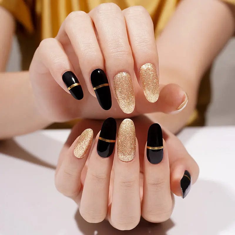 Black and gold glitter gel nail wraps on hands creating elegant party manicure
