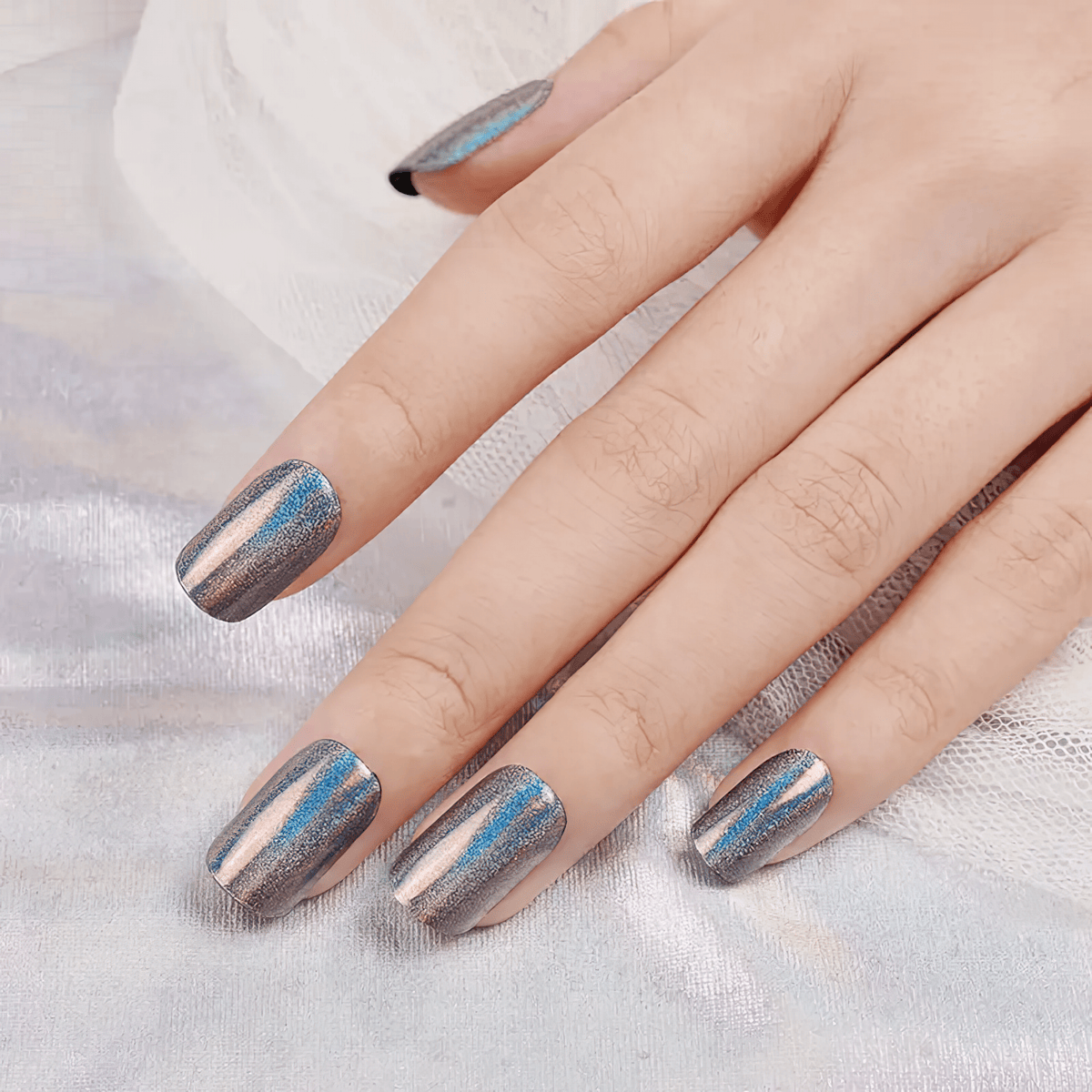 Metallic rainbow prism gel nail wraps with multichrome finish on fingertips