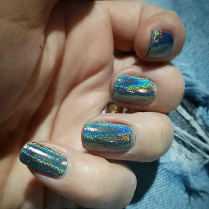 Multichrome rainbow prism gel wraps with metallic blue holographic finish on hand