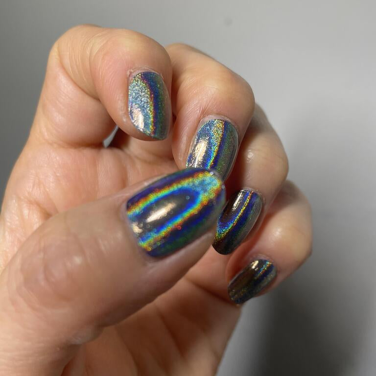 Holographic rainbow chrome gel nail wraps on hand showing multichrome prismatic finish