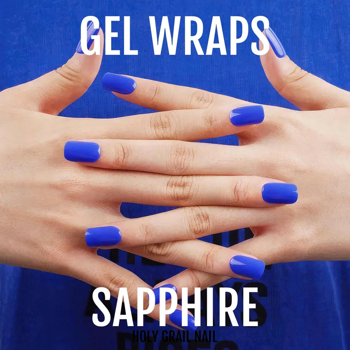 Royal blue gel nail wraps on hands showing glossy sapphire finish manicure