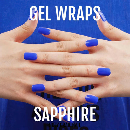 Royal blue gel nail wraps on hands showing glossy sapphire finish manicure
