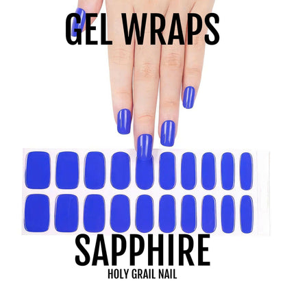 Sapphire blue gel nail wraps on hand showing glossy royal blue manicure finish