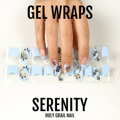 Blue gel nail wraps with delicate botanical leaf patterns on hand model