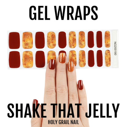 Autumn gel nail wraps in burgundy and amber glitter on hand showing warm seasonal nail art