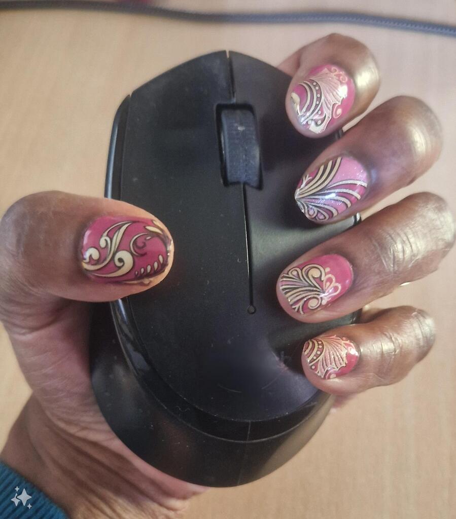 Hand holding mouse displaying pink gel nail wraps with metallic baroque swirl nail art
