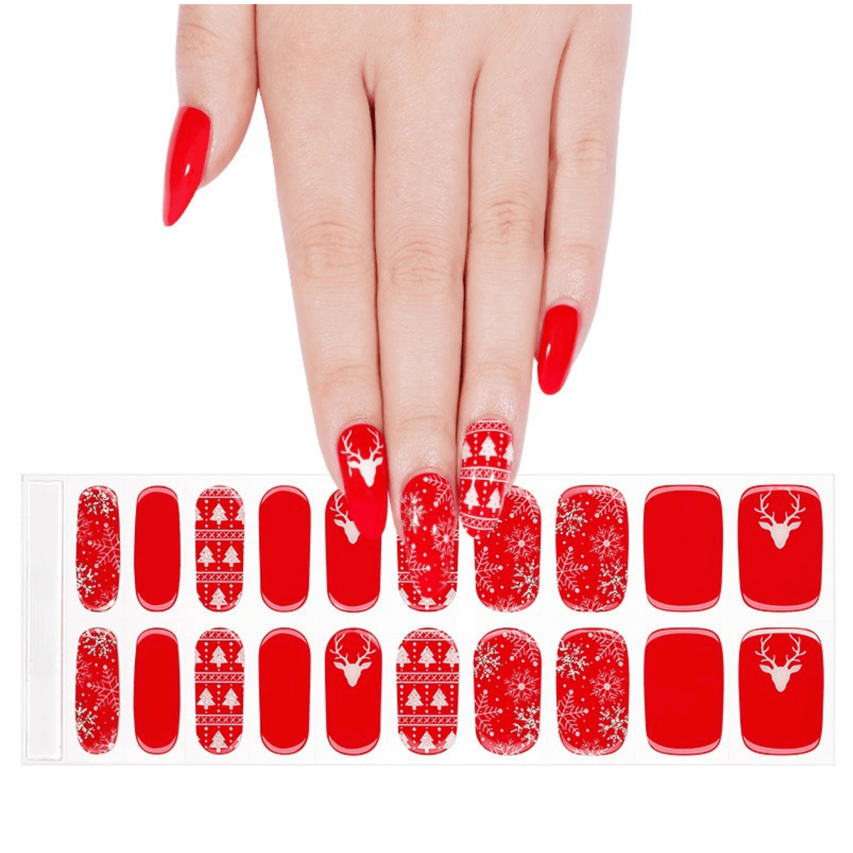 Festive red gel nail wraps with white Nordic reindeer patterns displayed with hand