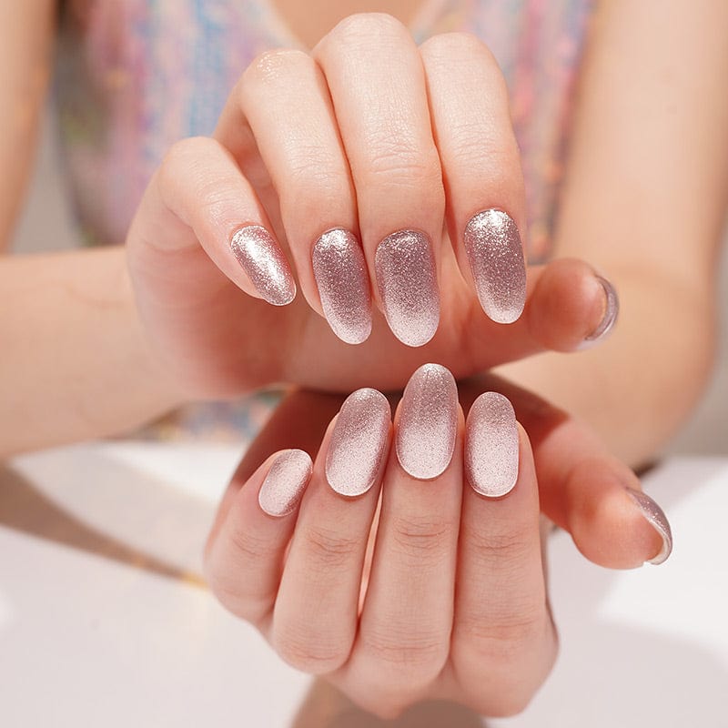 Rose gold glitter gel nail wraps on hands showing sparkly gradient manicure finish
