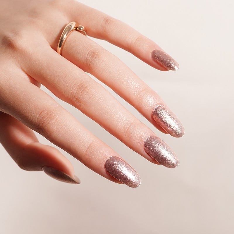 Rose gold metallic glitter gel nail wraps on hand showing shimmer finish
