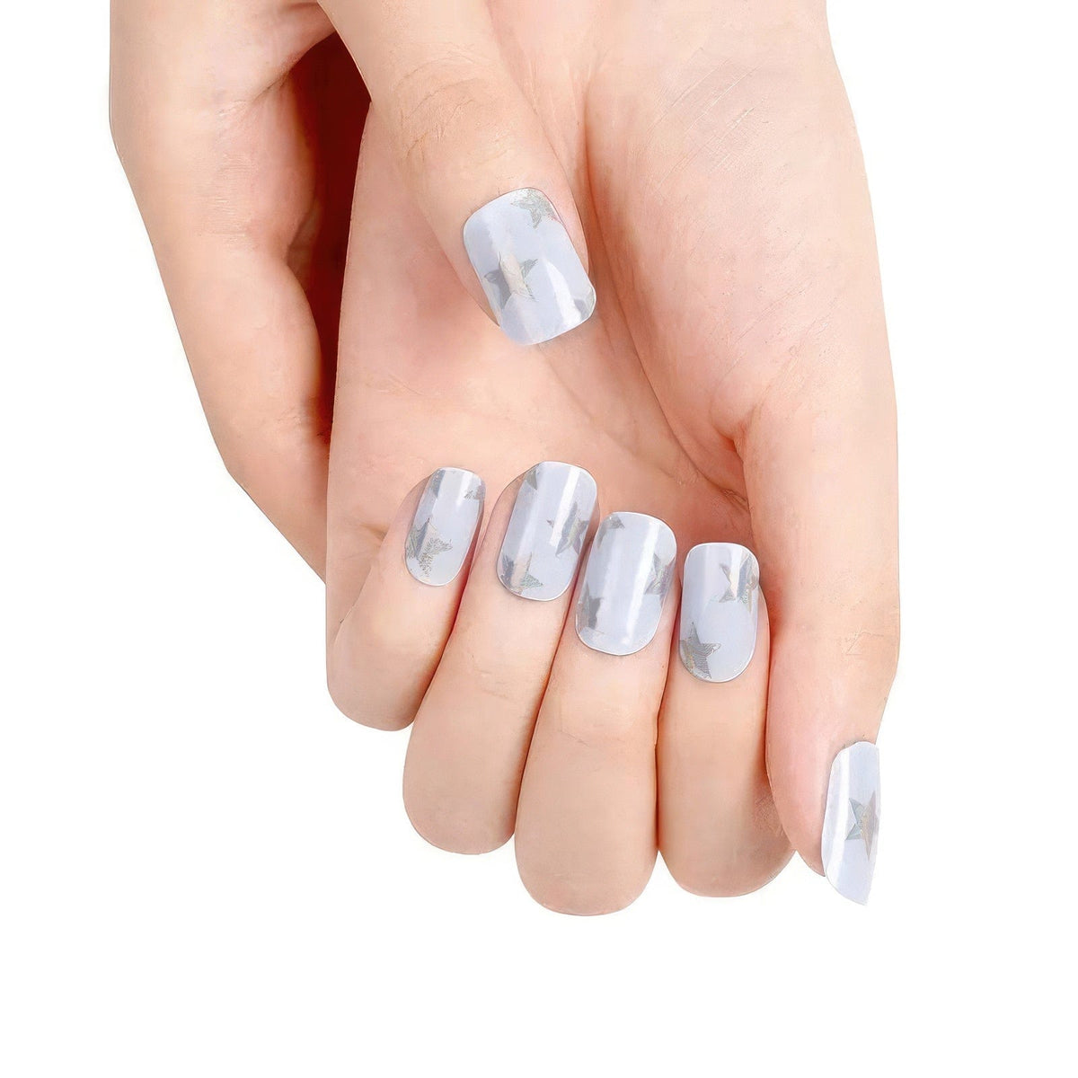 Blue sparkly gel nail wraps with silver stars on hand manicure