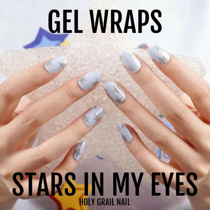 Blue glittery gel nail wraps with star design on both hands manicure