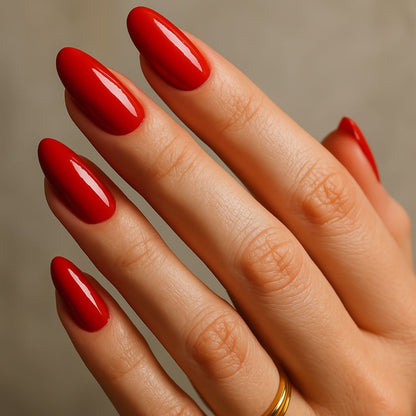 Close up red gel nail wraps on fingertips with high gloss finish