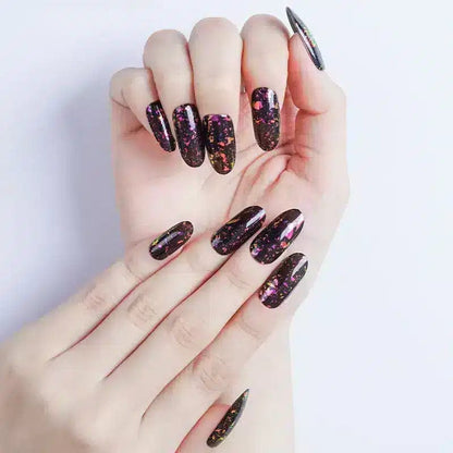 Black holographic glitter gel nail wraps on both hands with rainbow sparkle metallic finish