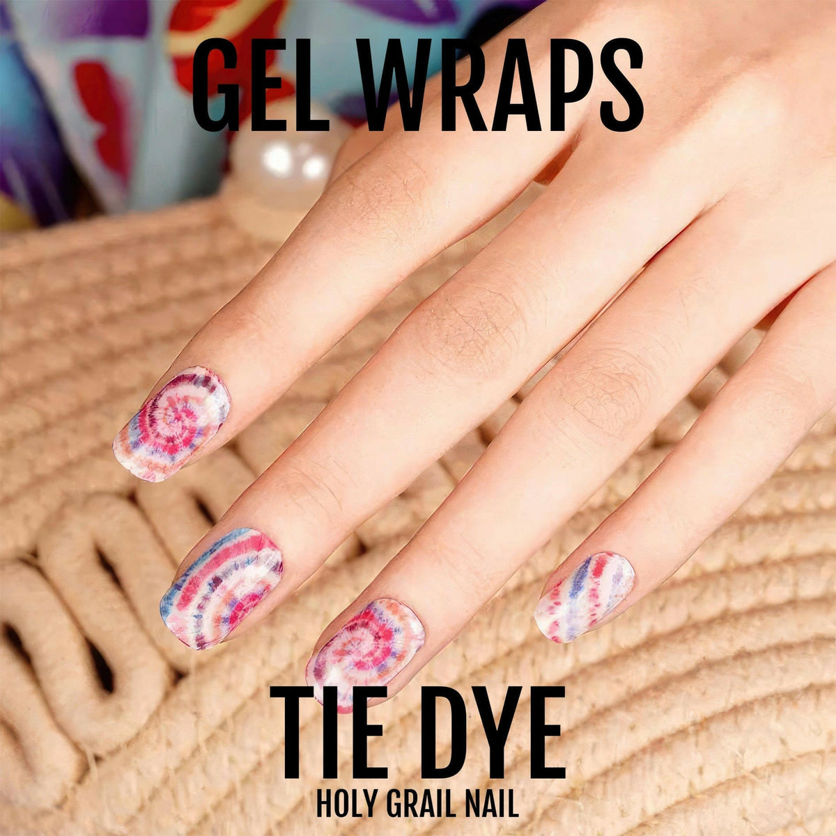 Pink and purple tie dye gel nail wraps worn on hand showing swirl pattern
