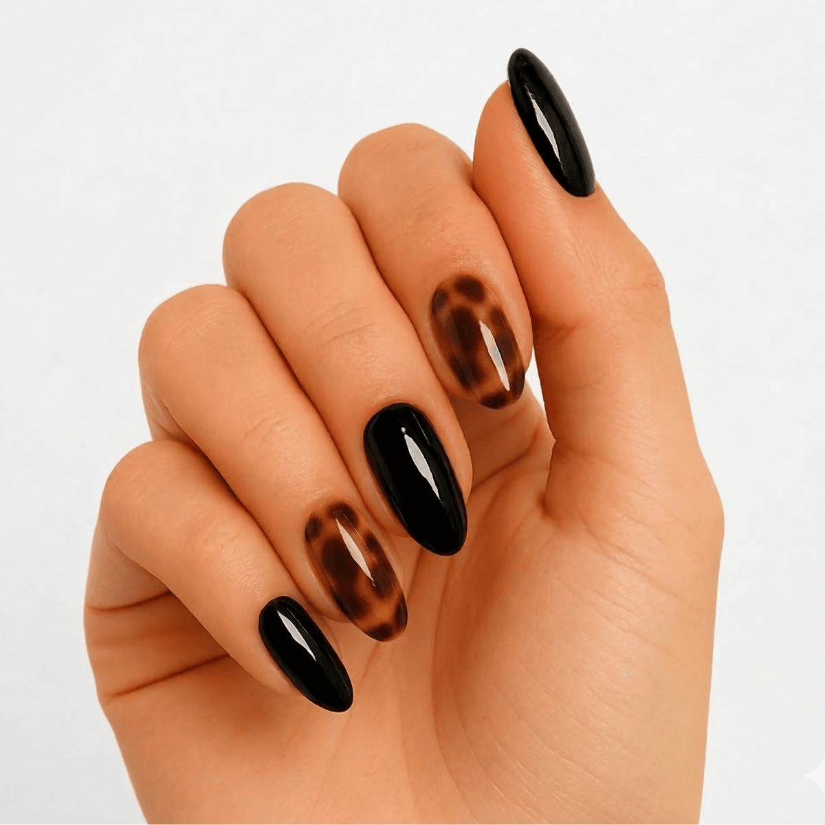Black and brown tortoiseshell gel nails with glossy finish on hand