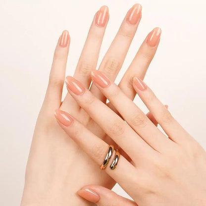Coral peach gel nail wraps on hands showing glossy manicure finish